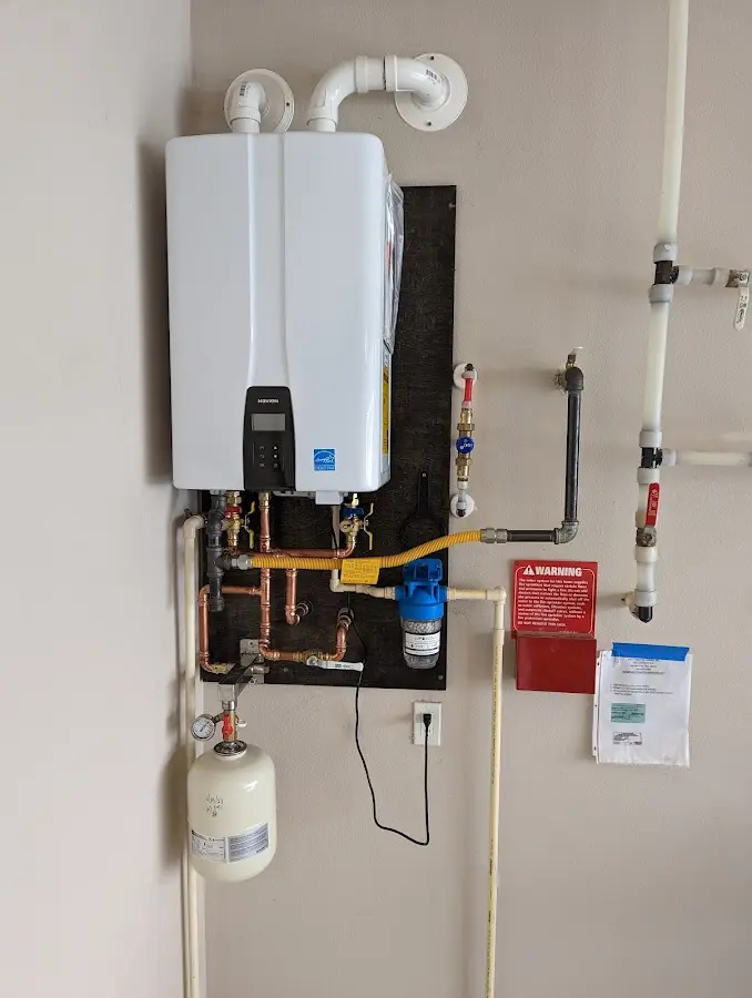 Professional plumber installing copper piping in a Bloomfield home